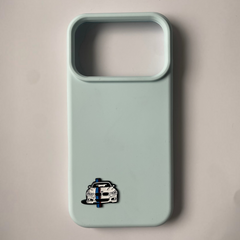 Pinkgul.no light blue phone case with a decorative metal car emblem sticker featuring a BMW design