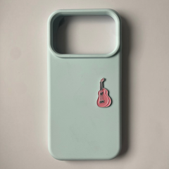 Pinkgul.no decorative pink guitar metal sticker applied to a light green smartphone case