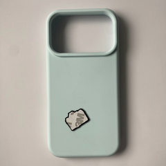 Pinkgul.no decorative metal sticker with adhesive backing applied to a light blue smartphone case