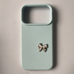 Pinkgul.no light blue phone case with a small, decorative, raised metallic bow sticker attached to the back.