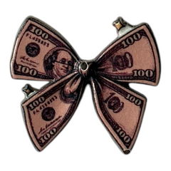 Pinkgul.no decorative metal sticker shaped like a bow with a 100 dollar bill print and raised texture