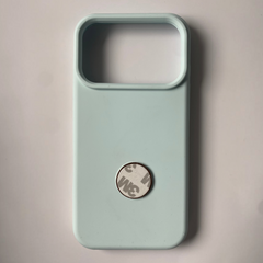 Pinkgul.no decorative metal sticker with strong adhesive backing, shown attached to a light blue phone case.
