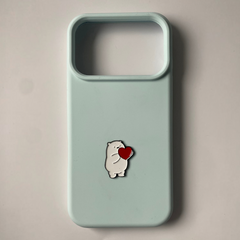 Pinkgul.no decorative metal sticker featuring a cute white bear holding a red heart on a light blue phone case