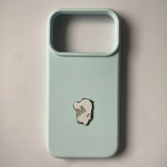 Pinkgul.no decorative metal sticker with adhesive backing applied to the back of a light blue smartphone case
