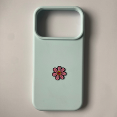Pinkgul.no light blue phone case featuring a small, decorative pink flower metal sticker with a raised design.