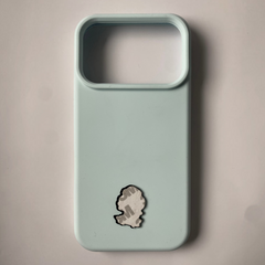 Pinkgul.no decorative metal sticker with adhesive backing applied to a light blue smartphone case