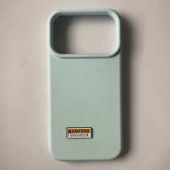 Pinkgul.no light blue phone case featuring a small rectangular Caution Engineer metal decorative sticker