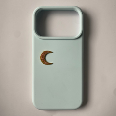 Pinkgul.no decorative gold metal crescent moon sticker applied to a light blue smartphone case