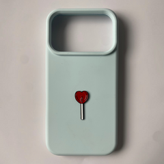 Pinkgul.no light blue silicone phone case featuring a small red heart-shaped lollipop charm