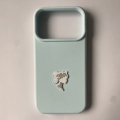 Pinkgul.no decorative metal sticker with a raised silhouette design attached to a light blue smartphone case