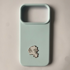 Pinkgul.no decorative metal sticker with strong adhesive backing applied to a light blue smartphone case