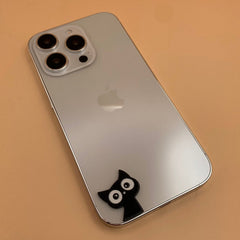 Pinkgul.no decorative black cat metal sticker applied to the back of a silver smartphone