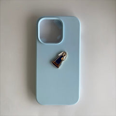 Pinkgul.no decorative metal sticker featuring a blue bunad design applied to a light blue smartphone case.
