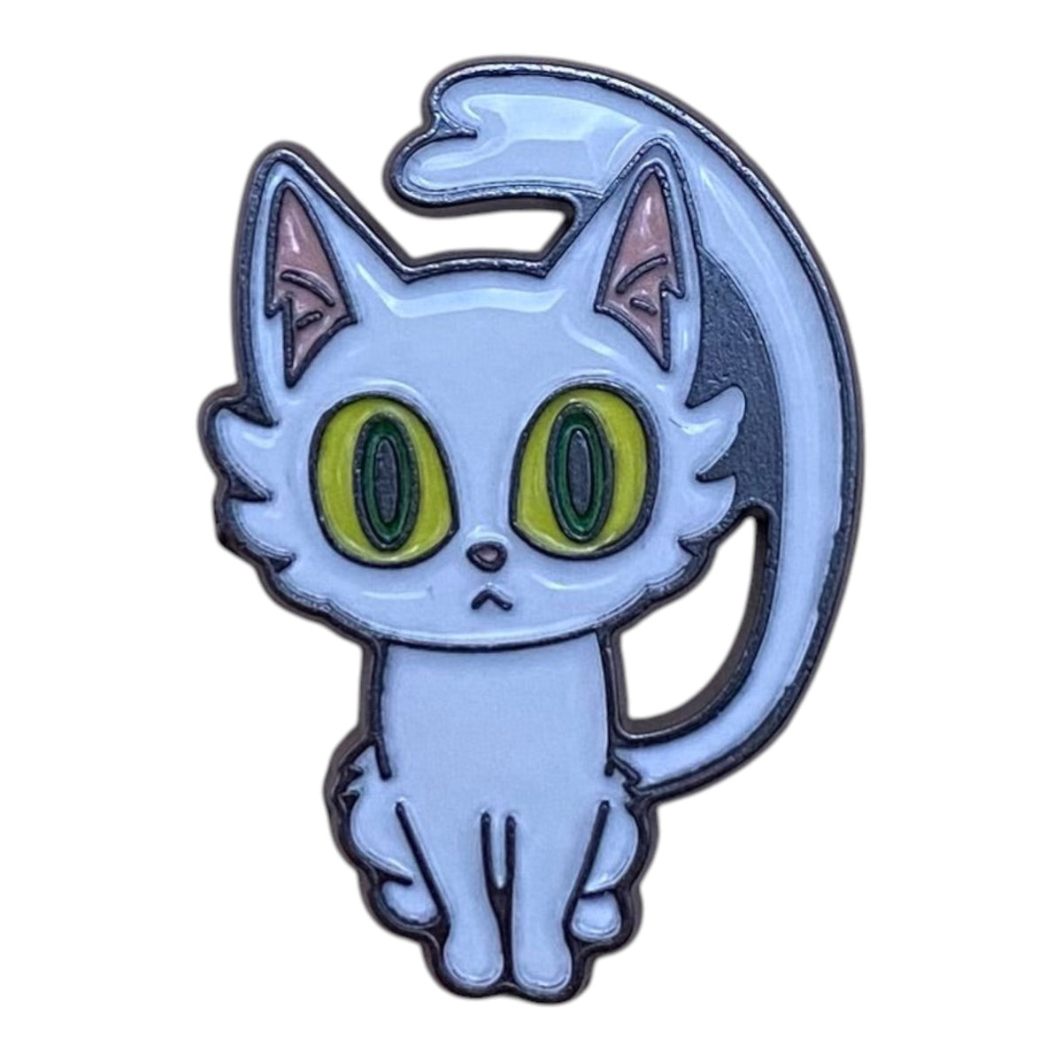 Pinkgul.no decorative metal sticker featuring a cute light blue cat with large green eyes and a raised design.
