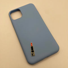 Pinkgul.no blue phone case with a decorative metal lipstick sticker featuring the elf logo on a beige background