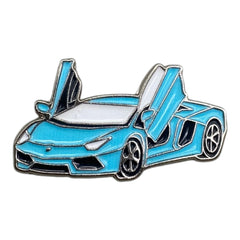 Pinkgul.no decorative metal sticker featuring a light blue sports car with iconic scissor doors and a raised design.