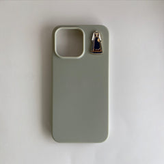 Pinkgul.no decorative metal sticker featuring a blue bunad design applied to a sage green smartphone case