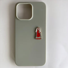 Pinkgul.no decorative metal sticker featuring a red traditional Norwegian Bunad dress on a sage green phone case.