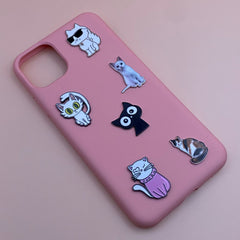 Pinkgul.no pink phone case decorated with various cat-themed metal stickers featuring cute and cool feline designs.