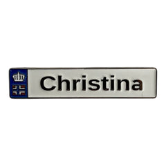 Pinkgul.no Christina decorative metal sticker with a raised crown and flag emblem on a white rectangular background.