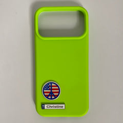 Pinkgul.no Christine decorative metal sticker on a bright neon green smartphone case with a peace sign emblem