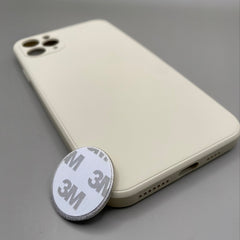 Pinkgul.no decorative metal sticker with 3M adhesive backing placed next to a cream-colored smartphone case.