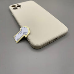 Pinkgul.no decorative gold metal sticker with adhesive backing placed next to a beige smartphone case