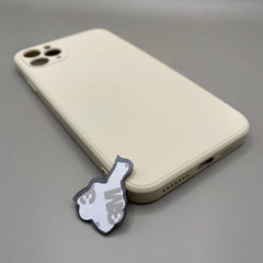 Pinkgul.no decorative metal sticker with adhesive backing placed next to a beige smartphone case