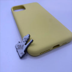 Pinkgul.no decorative metal sticker with 3M adhesive backing placed next to a yellow silicone phone case