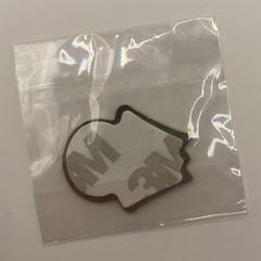 Pinkgul.no decorative metal sticker in a clear protective plastic bag with adhesive backing visible