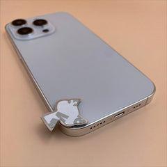 Pinkgul.no decorative metal sticker with a raised design applied to the back of a light blue smartphone
