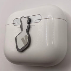 Pinkgul.no decorative metal sticker with a raised design applied to a white wireless earphone charging case.