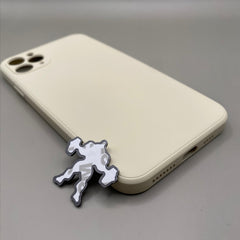 Pinkgul.no decorative metal sticker with a raised abstract design applied to a beige smartphone case