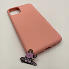 Pinkgul.no decorative metal sticker featuring a girl with a laptop and books, placed on a soft pink phone case.