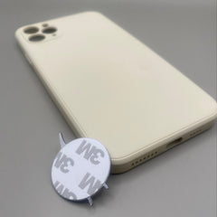 Pinkgul.no decorative round metal sticker with strong adhesive backing placed next to a beige smartphone case