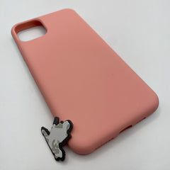 Pinkgul.no decorative metal sticker placed next to a smooth pink silicone mobile phone case on a white background