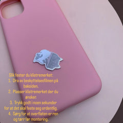 Pinkgul.no decorative metal sticker with adhesive backing applied to a smooth pink phone case
