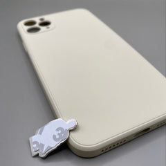Pinkgul.no decorative metal sticker with adhesive backing placed next to a beige smartphone case