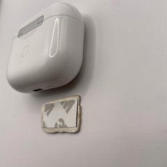 Pinkgul.no decorative metal sticker with adhesive backing next to a white wireless charging case