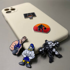 Pinkgul.no decorative metal stickers featuring gym and basketball themes applied to a beige smartphone case