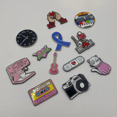 Pinkgul.no decorative metal stickers featuring various colorful designs like a camera, cassette, and cat.