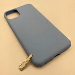 Pinkgul.no decorative gold metal sticker shaped like a lipstick tube placed next to a matte blue phone case