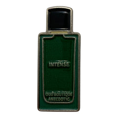 Pinkgul.no decorative metal sticker shaped like a green perfume bottle with raised Intense Oud Boutique Anecdotic text