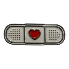Pinkgul.no decorative metal sticker shaped like a white adhesive bandage with a small red heart in the center