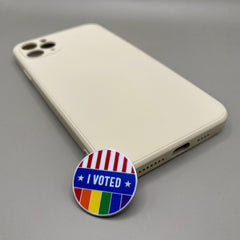 Pinkgul.no decorative metal I Voted sticker with rainbow and flag design on a smartphone case