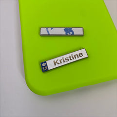 Pinkgul.no Kristine decorative metal sticker with a raised design and strong adhesive on a bright green surface