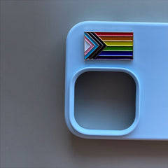 Pinkgul.no LGBTQ pride flag metal sticker applied to a light blue smartphone case