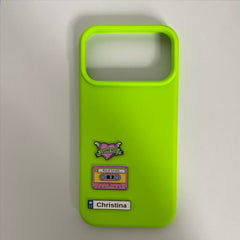 Pinkgul.no bright lime green phone case decorated with Christina metal sticker, heart, and retro cassette tape charms