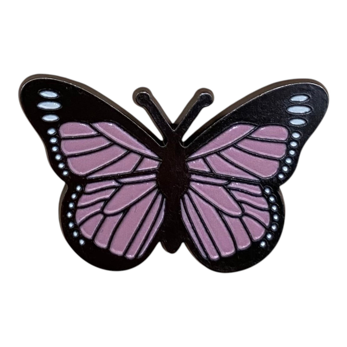 Pinkgul.no decorative metal butterfly sticker with a raised design in black and pink on a neutral background.