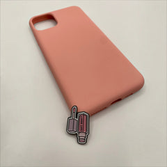 Pinkgul.no decorative metal sticker shaped like a Fenty Beauty lip gloss attached to a plain peach phone case